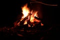 Warm and cozy campfire in night with embers flying