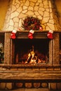 Warm cozy fireplace decorated for Christmas with real wood burni
