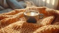 Warm cup of coffee on a cozy knitted blanket Royalty Free Stock Photo