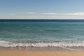 Warm day on a Cannes beach with azure waves of mediterranean sea