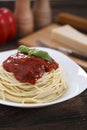 Warm, delicious spaghetti with sauce and basil.