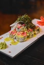 Warm delicious warm sushi with salmon, avocado and nori on the table. Tasty, appetizing and savory Sushi set Royalty Free Stock Photo