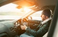 Warm dressed Bearded Man driving a new modern auto. Inside car v