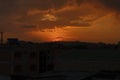 warm dusk with cloudy sky and cityscape silhouettes