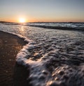 Warm evening sunset on the Black Sea coast and foamy sea waves in motion Royalty Free Stock Photo