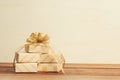 Warm filtered gifts wrapped in natural craft paper on wood