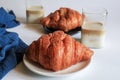 Warm Fresh Buttery Croissants with coffee for breakfast. French and American Croissants and Baked Pastries. Royalty Free Stock Photo