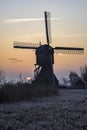 Warm and frozen windmill sunrise Royalty Free Stock Photo