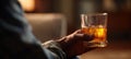 The Warm Glass of Whiskey Held in a Relaxed Hand at Home AI generated image Royalty Free Stock Photo