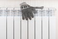 Warm gloves on the radiator. Heating season concept Royalty Free Stock Photo