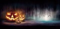 Warm glow of Jack O` Lanterns on a wood bench