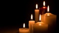Warm glow of multiple lit candles in a dark peaceful setting Royalty Free Stock Photo