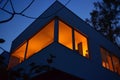 warm glow from windows of a cubeshaped modern home