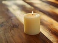 Warm glowing candle on rustic wooden table Royalty Free Stock Photo