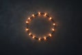 Warm Glowing String Lights Forming Circular Pattern on Dark Textured Background Royalty Free Stock Photo
