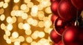 Warm Golden Bokeh Lights with Glossy Red Ornaments on Dark Christmas background flat lay Background Royalty Free Stock Photo