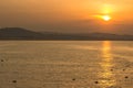 Golden hour sunset at Colwyn bay, North Wales. Warm sky with seagulls sitting on the water. Royalty Free Stock Photo