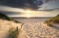 Warm golden sunshine over walking path to sea beach