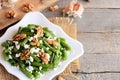 Warm green bean salad recipe. Balsamic green beans salad with creamy cheese, crunchy walnuts, garlic and spices on a plate