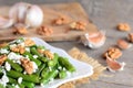 Warm green string beans salad. Green string beans salad with cottage cheese, raw walnuts, garlic and spices on a plate