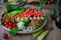 Warm grilled chicken salad with vegetables and fruits