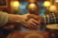 Warm handshake in an ambient room, showcasing mutual respect and agreement Royalty Free Stock Photo