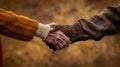 Warm Handshake in Autumn Setting.AI generated image Royalty Free Stock Photo