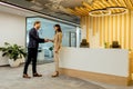 Warm Handshake Between Colleagues In Modern Office Lobby Under Ambient Lighting Royalty Free Stock Photo