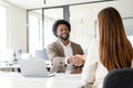 A warm handshake between a man and a woman in a contemporary office Royalty Free Stock Photo