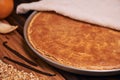 Warm Homemade Italian Ricotta Cheesecake with chopped candied orange peels on wooden background.