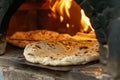 Traditional Stone Oven Baking Fresh Flatbread, Ideal for Culinary Websites and Cultural Blogs Royalty Free Stock Photo