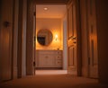 Warm and inviting view of open bathroom door in empty house, showcasing soft lighting and circular mirror, creating serene Royalty Free Stock Photo