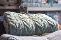 Warm knitted blankets folded stack. Plaid mint color over blue h