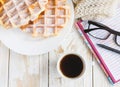 Warm knitted plaid, coffee, notebook and Belgium waffles