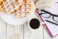 Warm knitted plaid, coffee, notebook and Belgium waffles