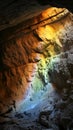 Warm light cascades over rocky cave walls, illuminating the textures and contours in a subterranean setting Royalty Free Stock Photo