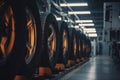 Warm light highlighting the tire installation process on a car manufacturing assembly line