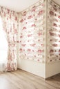 Warm light through sheer white tulle and vintage floral curtains, blinds with red roses in the bedroom. Interior design
