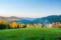 Warm light sunset panorama view of Beskydy mountains with fog in the valley and blue cloudless sky, beutiful sunny afternoon in