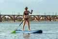 Young attractive woman standing on paddle board, SUP. Active life, sport, leisure activity concept Royalty Free Stock Photo