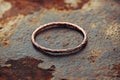 Warm lighting highlights a copper ring with several bands as it rests on a surface that has a distinctive texture Royalty Free Stock Photo