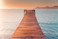 Warm morning light in summer vacation holiday resort. Pier in orange sunrise colors