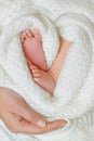 A warm mother`s heart for tiny cute newborn feets