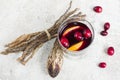 Warm mulled wine with citrus, cranberries and spices with woode