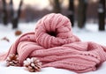 Warm pink wool scarf in the snow. Winter time. AI generated