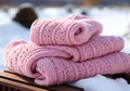 Warm pink wool scarf in the snow. Winter time. AI generated
