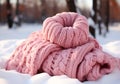 Warm pink wool scarf in the snow. Winter time. AI generated