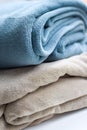 Warm plaids gray-turquoise and beige are folded on top of each other Royalty Free Stock Photo