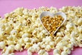 Warm popcorn viewed from above on pink background. Top view. Enterteinment concept