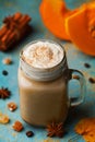 Warm pumpkin spiced latte or coffee in cup decorated cinnamon and anise on blue vintage background. Autumn, fall, winter hot drink Royalty Free Stock Photo